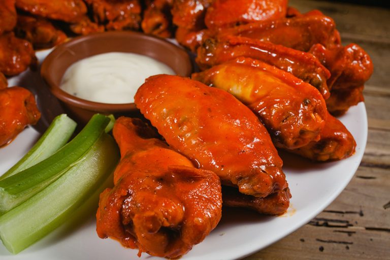 Chicken wings, spicy food and cheese dip. (Photo: Adobe Stock │ #201442289 - Marcos)