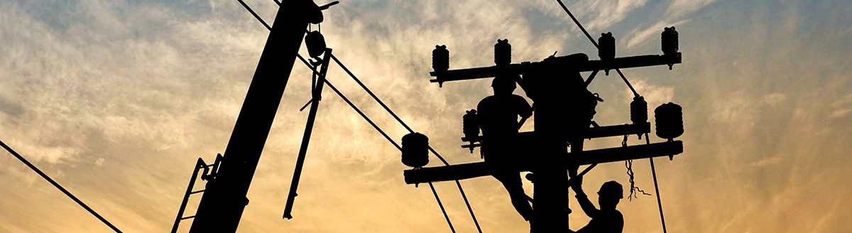 Silhouette electricians team with crane are working to install electrical transmission equipment on power pole (Photo: Adobe Stock │ #253451746 - Prapat)