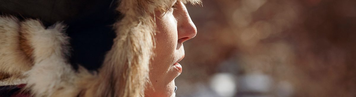 Woman wearing warm clothing standing outdoors. (Photo: Adobe Stock │ #298319443 - Cavan for Adobe)