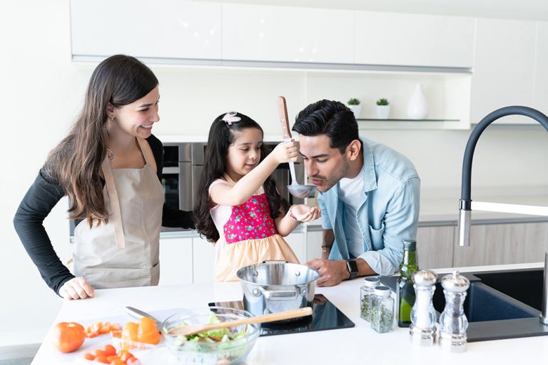 Family cooking food together at home. (Adobe Stock │ #371465448 - AntonioDiaz)