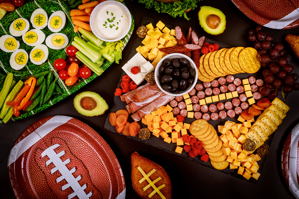 Delicious charcuterie board and veggie with dipping for American football game.(Adobe Stock │ #383201995 - Olesya)