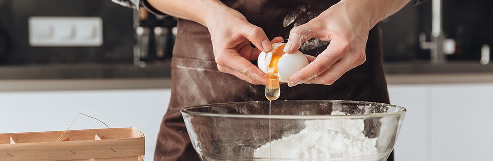 A young woman cooking the dough. (Adobe Stock │ #137054202 - Drobot Dean)
