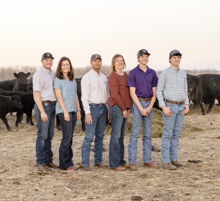 Darrell and Frina Kaiser of Kaiser Angus, Gove County, Kansas, are marking a quarter century of having a production sale. Pictured are, from left, Luke and his wife, Zoe, Darrell and Frina, Dalton and Trevor. (Courtesy photo.)