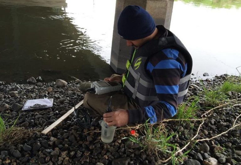 Sushant Mehan, assistant professor and SDSU Extension Water Resource Engineer Specialist, conducts water quality sampling at Skunk Creek near Sioux Falls. (Photo courtesy of Sushant Mehan)