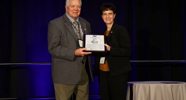 National Pork Producers Council 2024-2025 President Lori Stevermer presented Dr. Howard Hill with the NPPC Hall of Fame award in recognition of his contributions to the pork industry. (Courtesy photo.)