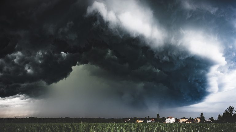Muddy wet countryside corn field and dark storm clouds. (Adobe Stock │ #259019240 - Przemyslaw Iciak)