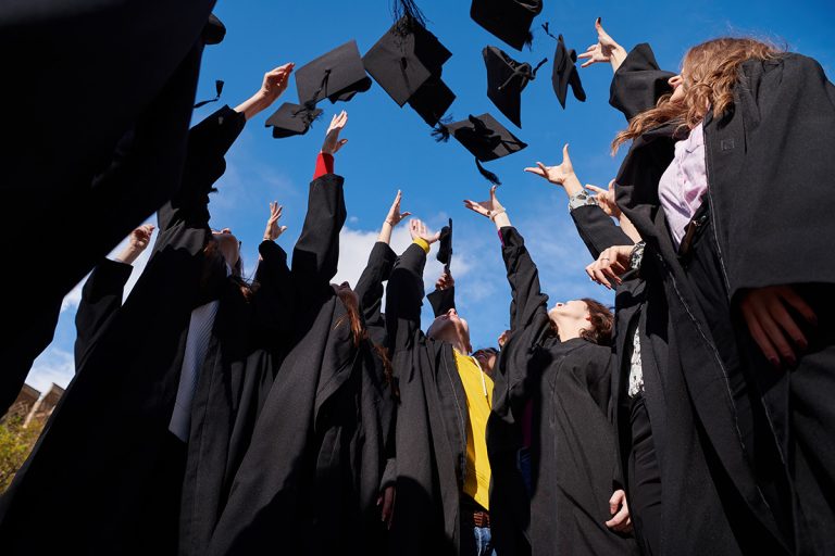 Group of international graduating students celebrating. (Adobe Stock │ #424444895 - shock)