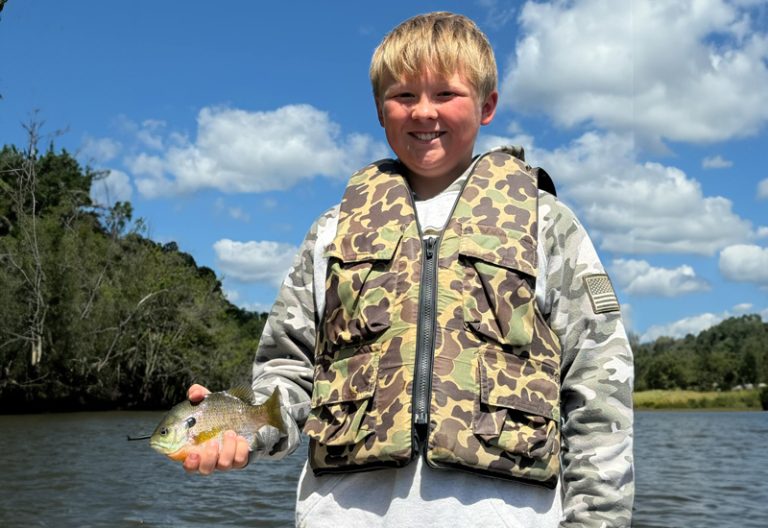 Brennen, a 4-H member from Jackson County, displays his fish, showcasing the joys of outdoor activities and fishing. (ISU Extension and Outreach)