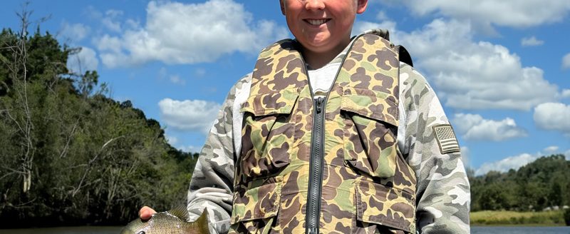 Brennen, a 4-H member from Jackson County, displays his fish, showcasing the joys of outdoor activities and fishing. (ISU Extension and Outreach)