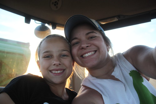Giving the farmer's daughter, Karissa, a little grain cart lesson.