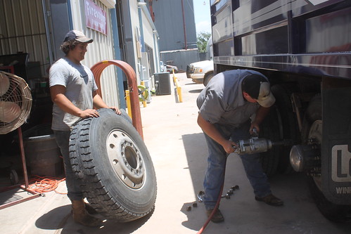 Putting the tire with the brand-spankin' new valve stem back on.