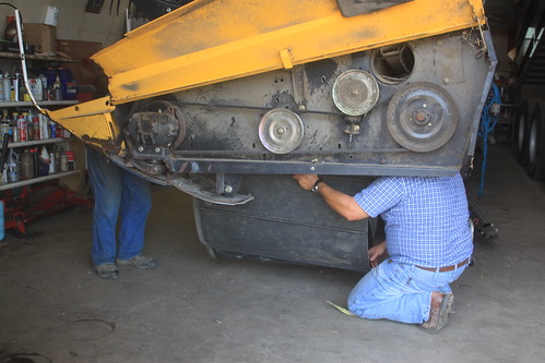 Grandpa Hiladore and Dad fixing the rollers on our header.