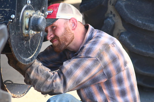 John checking over the clean grain elevator on the combine.