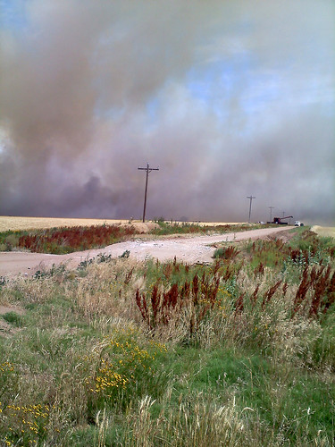 A combine prepares to dump in midst of the fire