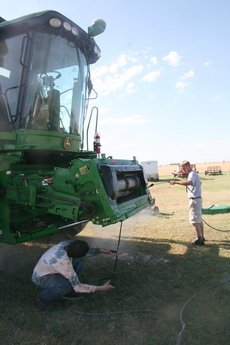 Adam and Adreas power wash off the combine.