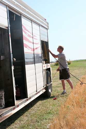 Rolly rolls up the hose after blowing off the tractor.