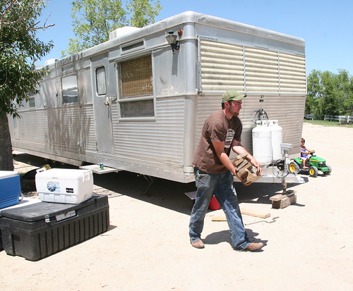 A rare moment. Everyone helps load the camper. James takes blocks to the pickup.
