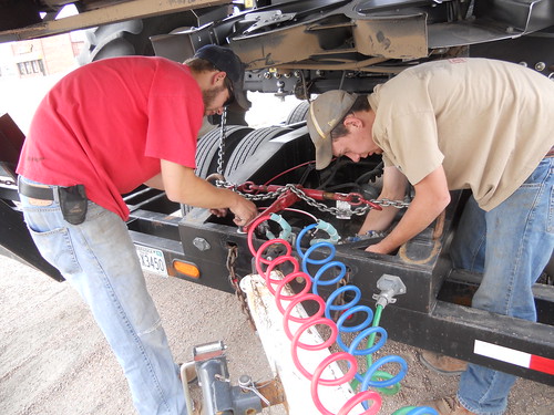James and Brandon hook up the dolly to the back of the combine trailer