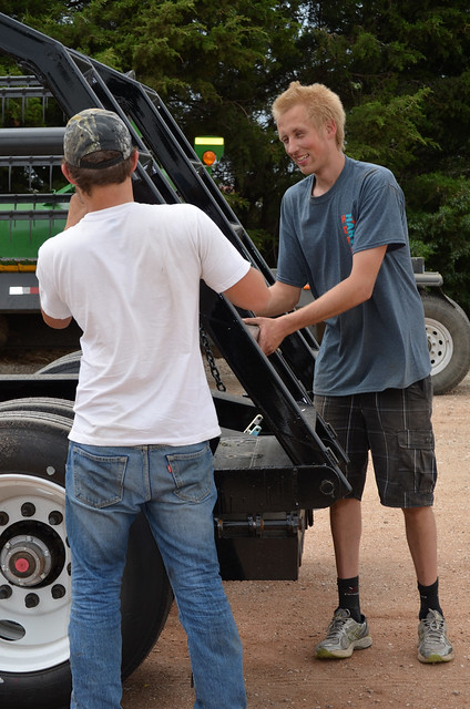 Martin helps Theo with the combine trailer ramps