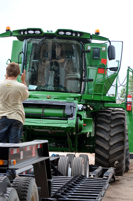 Kyle guides Oak as he loads the combine