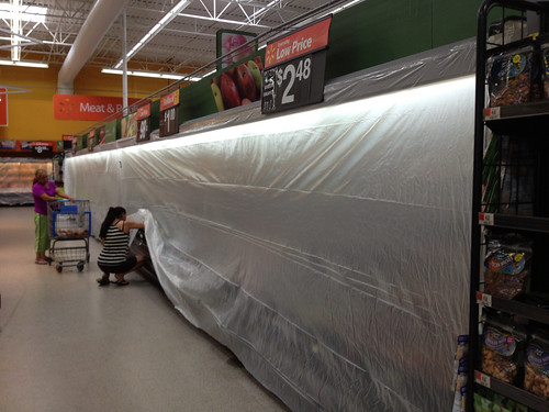 In attempts to save the produce from the 110 degree heat outdoors the Pratt Walmart covers the coolers