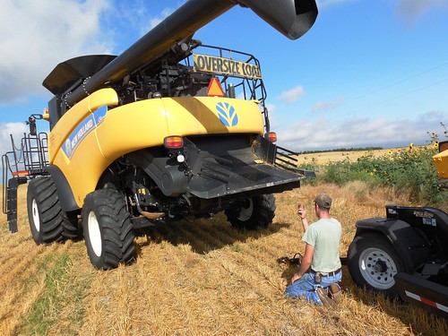 Eric hooking up the header to the combine