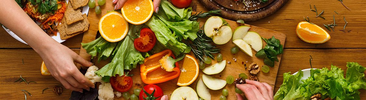 Dinner table, women eat healthy food at home kitchen. (Adobe Stock │ #152323446 - unrestedm)