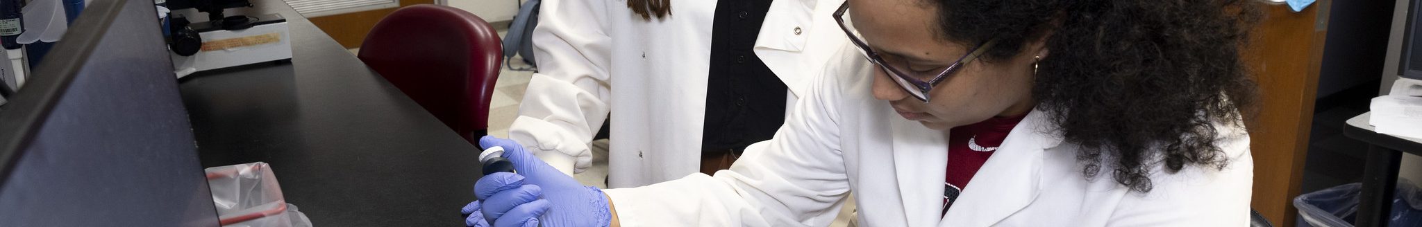 Danielle Graham, left, works alongside her advisee Karen Echevarria, a lab assistant and undergraduate student at the University of Arkansas majoring in animal science. (U of A System Division of Agriculture photo)