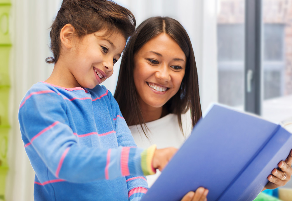 Happy mother and daughter reading a book. (Adobe Stock │ #454726100 - Syda Productions)