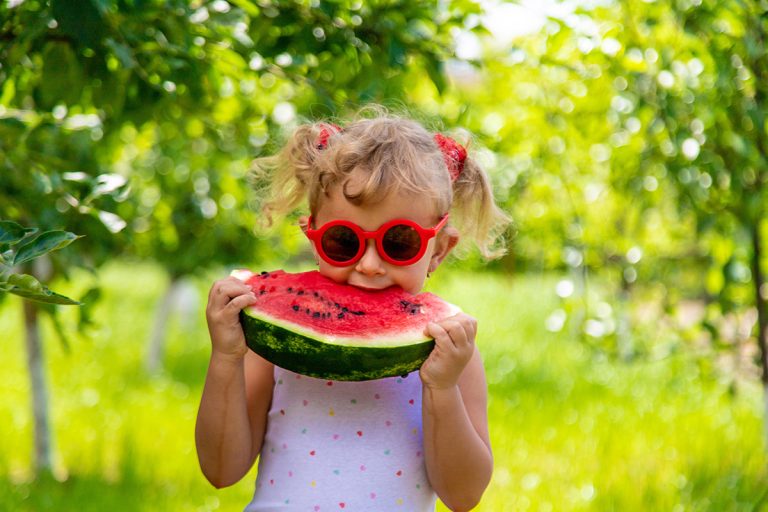 A child eats a watermelon. (Adobe Stock │ #660095202 - yanadjan)