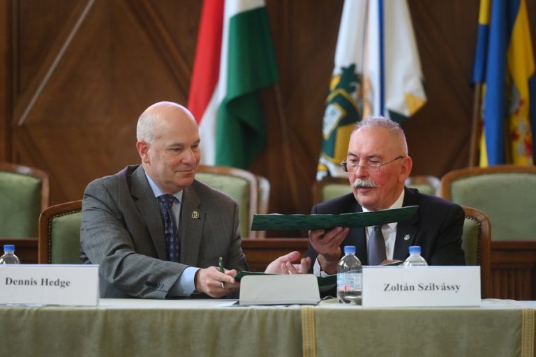 SDSU Provost and Vice President for Academic Affairs Dennis Hedge exchanges documents with University of Debrecen Rector Zoltán Szilvássy as part of an academic cooperation agreement signing last month in Hungary. (Image provided courtesy of the University of Debrecen.)