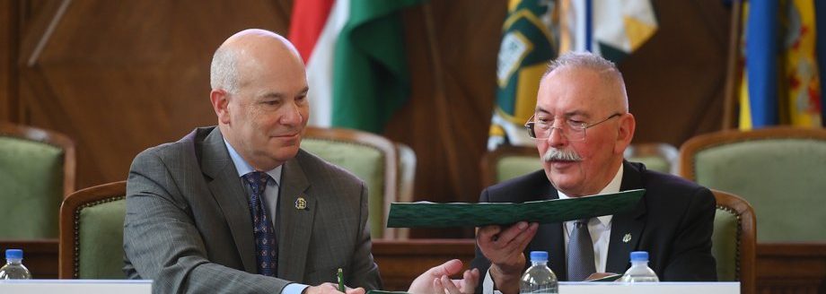 SDSU Provost and Vice President for Academic Affairs Dennis Hedge exchanges documents with University of Debrecen Rector Zoltán Szilvássy as part of an academic cooperation agreement signing last month in Hungary. (Image provided courtesy of the University of Debrecen.)