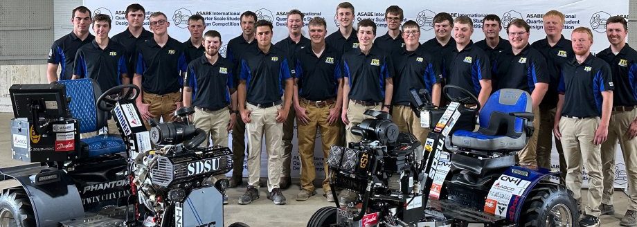 Members of the Jackrabbit Tractor Club assemble with their 2024, left, and 2025 entries at the International Quarter-Scale Tractor Student Design Competition at the Expo Gardens Fairgrounds in Peoria, Illinois. Entered in separate classes at this year’s competition, both placed second. (SDSU Extension)