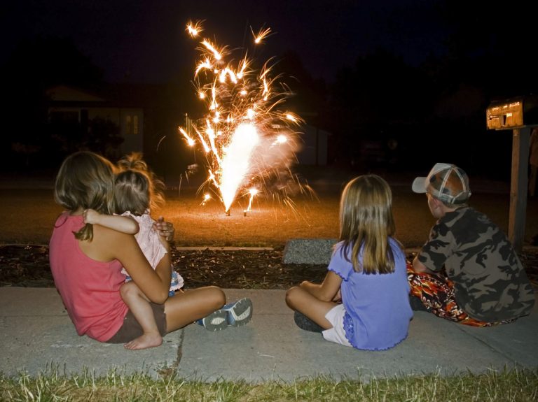 Kids watching fireworks at home. (iStock │ #121352424 - Renphoto)