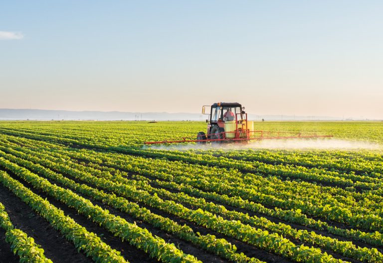 Tractor spraying soybean field. (iStock │ #506164764 - fotokostic)