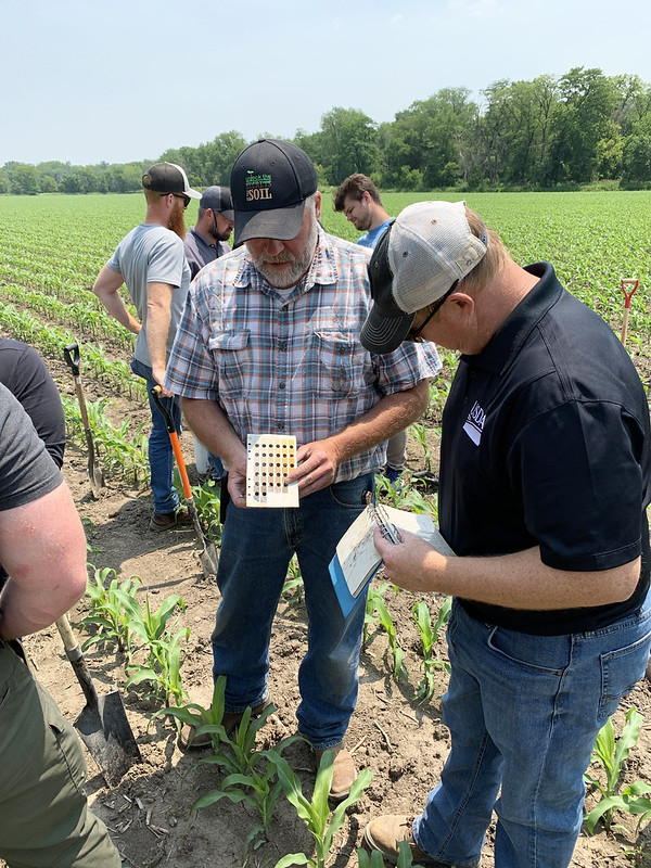 NRCS Soil Scientist Jason Steele (left) and Soil Health Specialist JD Hollingsworth review soil colors during a soil health training near Ainsworth on June 10, 2025. (Jason Johnson - Iowa NRCS)