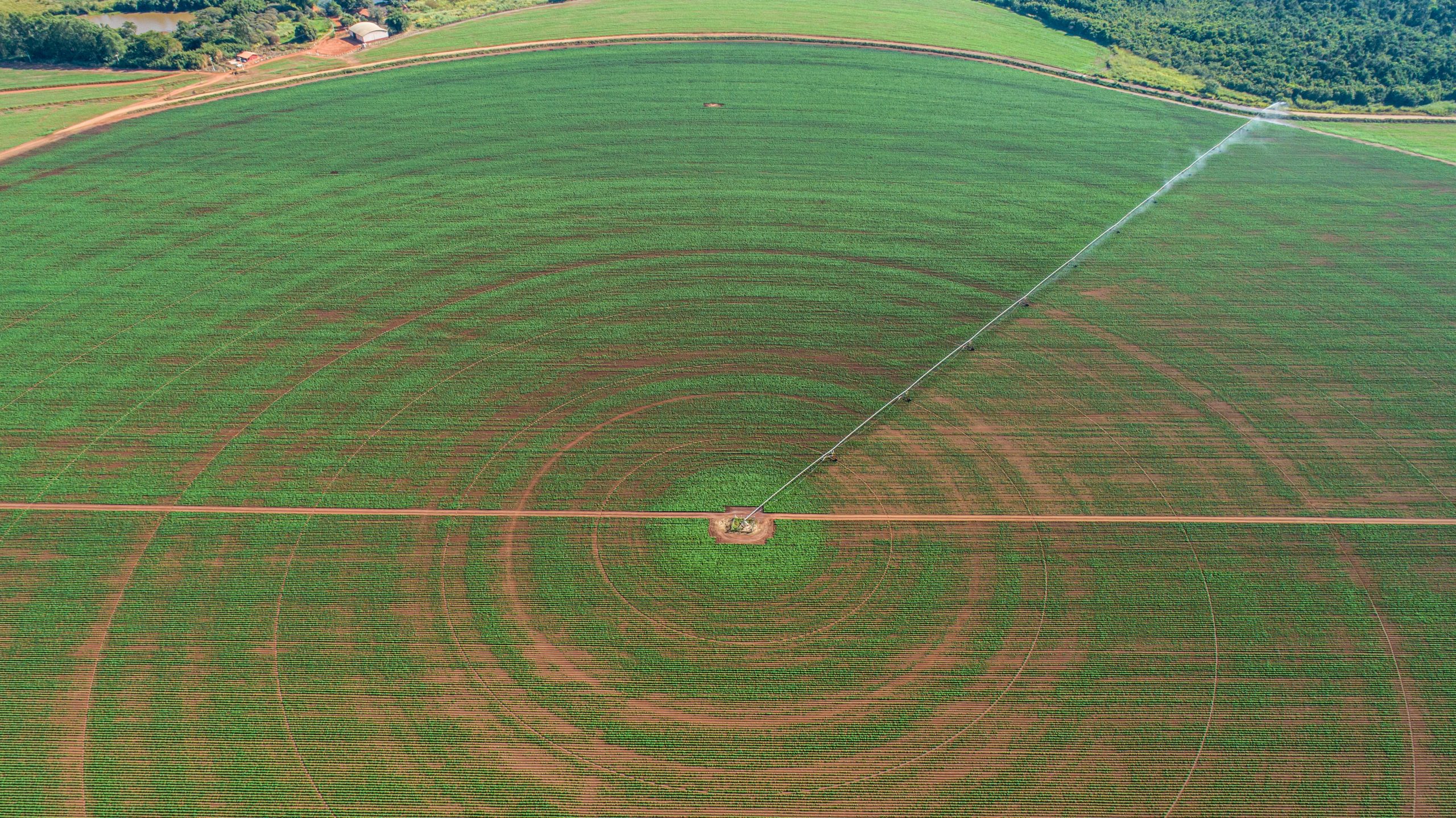 an agricultural irrigation system on sunny summer day. An aerial view of a center pivot sprinkler system. (Photo courtesy of AdobeStock.)