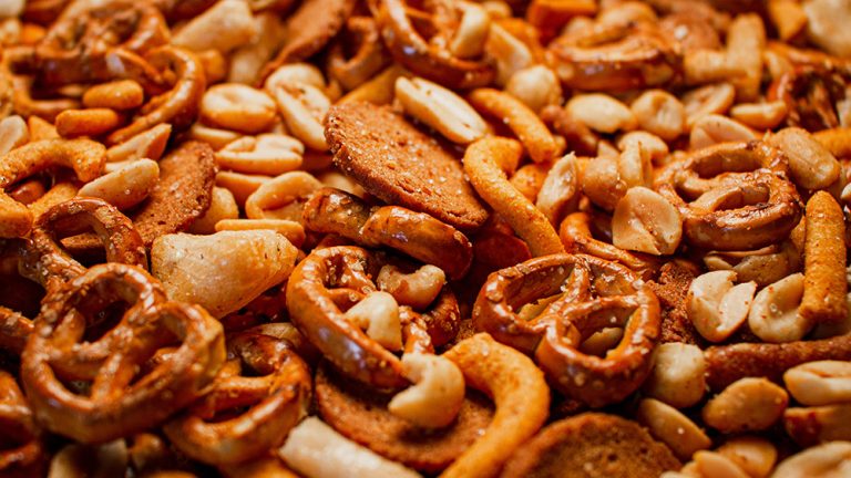 Trail mix snack, healthy crunchy nuts pretzels. (Adobe Stock │ #482729531 - DrewDuzz)