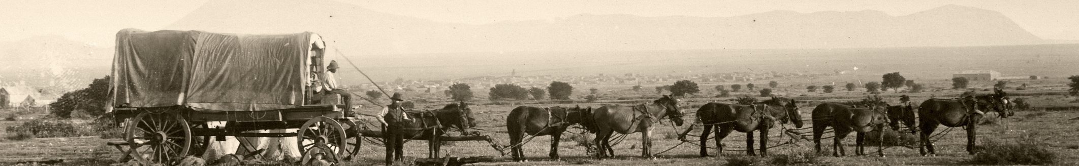 Vintage photograph of an old fashioned covered wagon pulled by a team of horses. (iStock │ #157331967 - duncan1890)