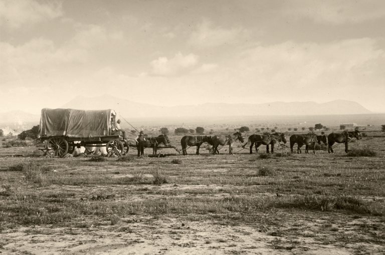 Vintage photograph of an old fashioned covered wagon pulled by a team of horses. (iStock │ #157331967 - duncan1890)