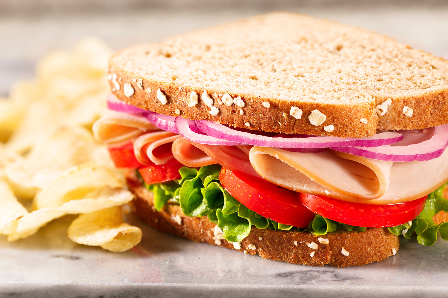 Ham and turkey sandwich with chips. (Adobe Stock │ #150082453 - lindahughes)