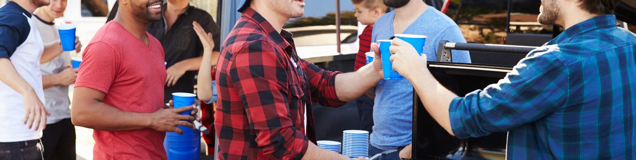 Group of sports fans tailgating at a stadium. (iStock │ #502868546 - monkeybusinessimages)
