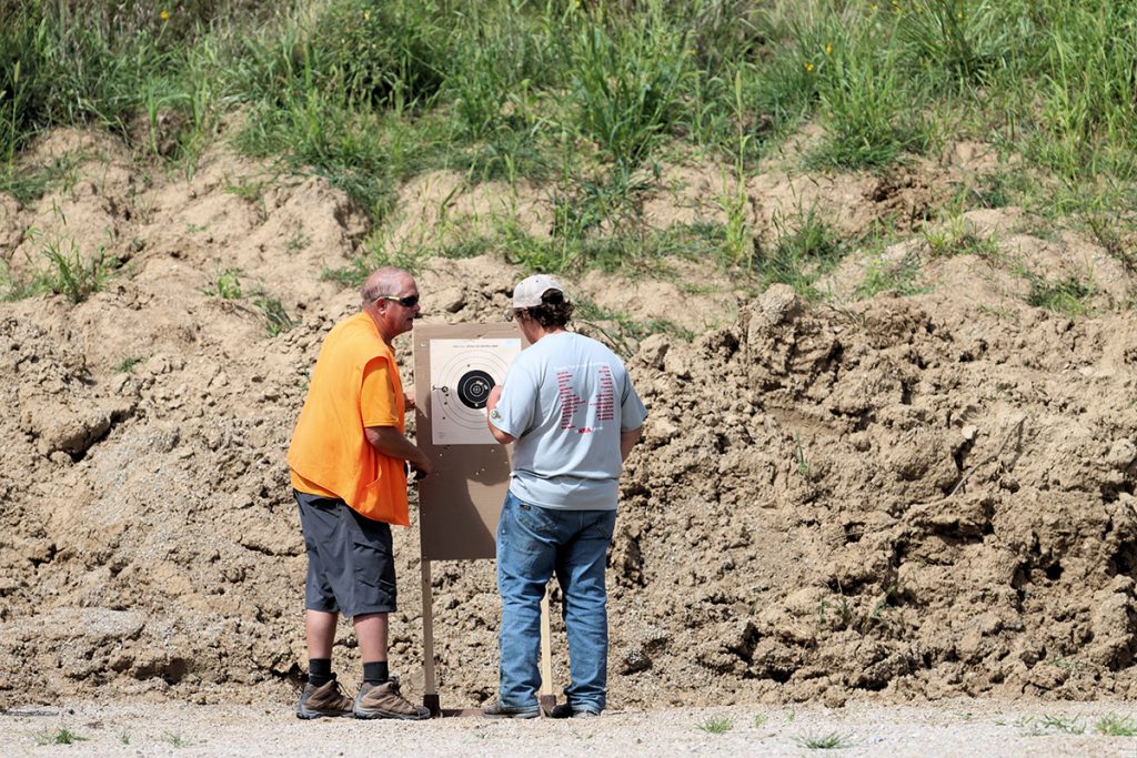 A youth competitor and muzzleloader instructor Joel Van Zante evaluate the target after completing a round. (Photo courtesy of Michael Kloth)