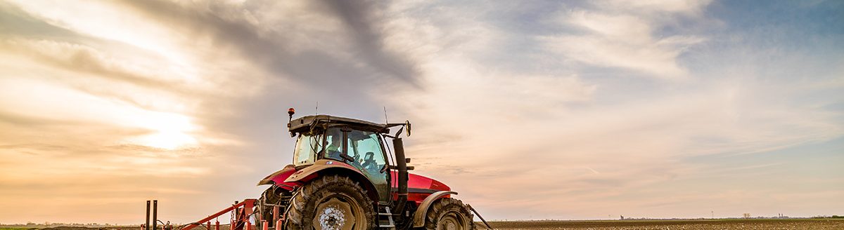 Tractor cultivating field at spring. (Adobe Stock │ #201749717 - oticki)