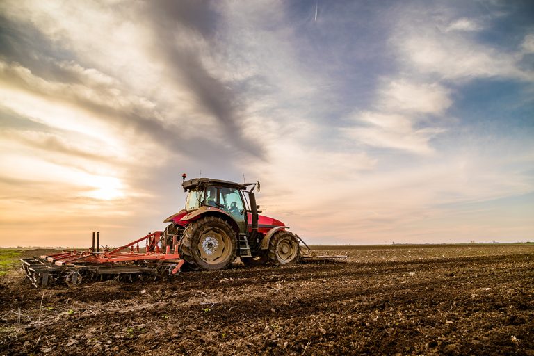 Tractor cultivating field at spring. (Adobe Stock │ #201749717 - oticki)