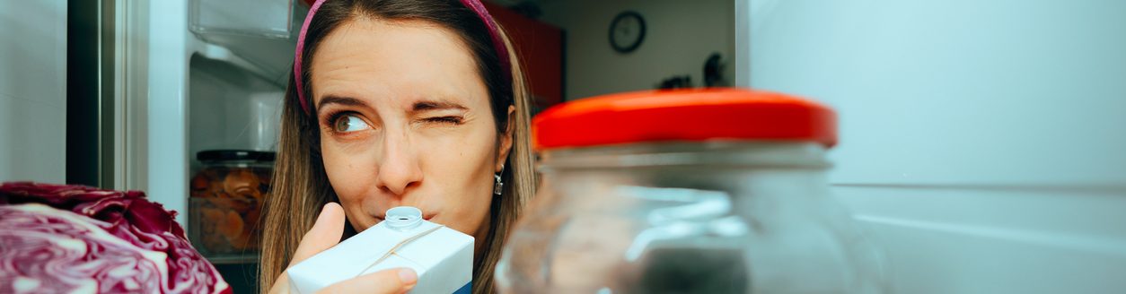 Cautious girl checking the smell of her diary product. (iStock │ #1838896474 - nicoletaionescu)
