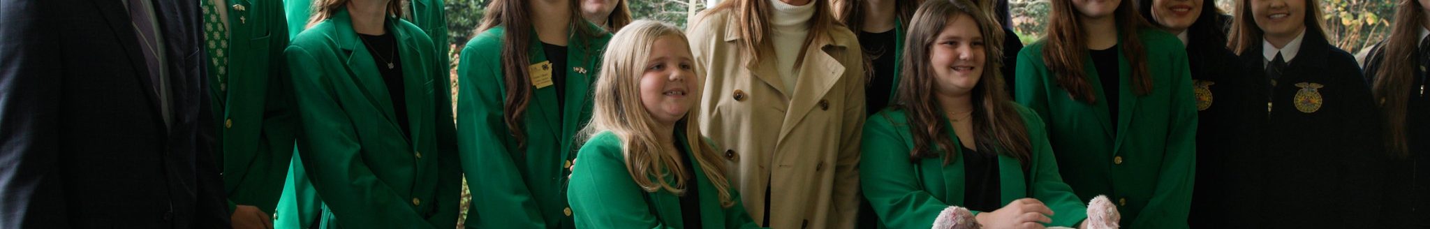 Arkansas Gov. Sarah Huckabee Sanders (center) poses for a photo with 4-H members Adeline Dixon and Caroline Dixon (front) who raised the turkeys that Sanders pardoned on Nov. 20, 2025, during a ceremony at the Governor's Mansion in Little Rock. With them are from left: Arkansas Agriculture Secretary Wes Ward, Arkansas 4-H State Officers team members, and FFA members. UADA photo / Ben Aaron