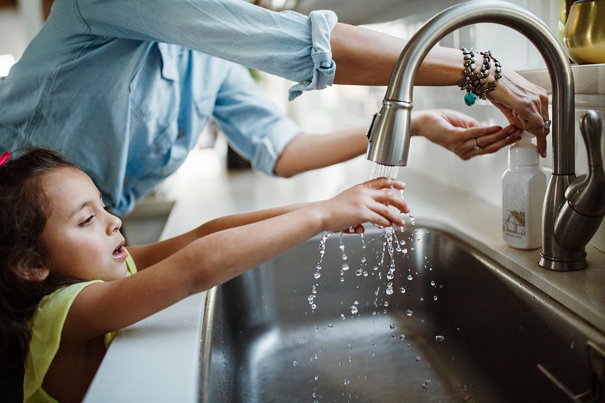 Mother with daughter washing hands in sink at home. (Adobe Stock │ #263075392 - Cavan for Adobe)