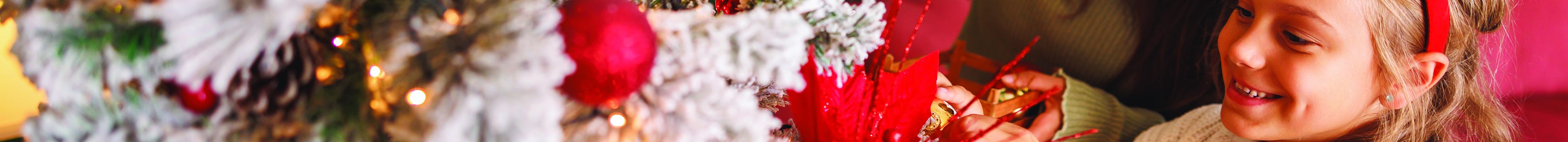 Mother and daughter hanging ornaments (Photo courtesy of Shutterstock)
