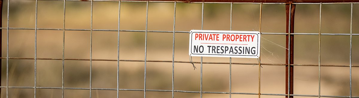 Private property signs cover a gate on some land in West Texas on Monday, Dec 05, 2022. (Sam Craft/Texas A&M AgriLife Marketing and Communications)